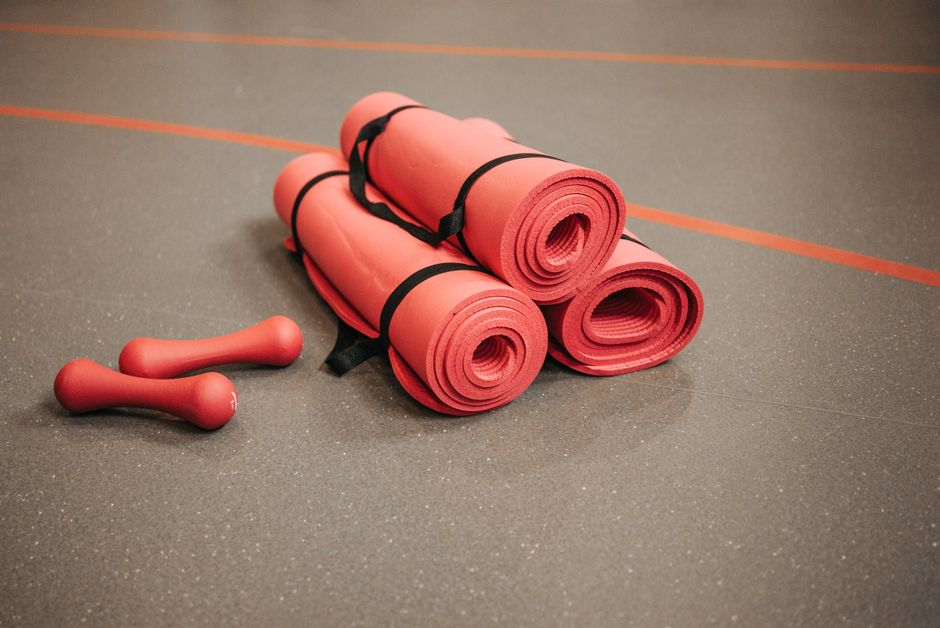 A row of neatly rolled yoga mats.